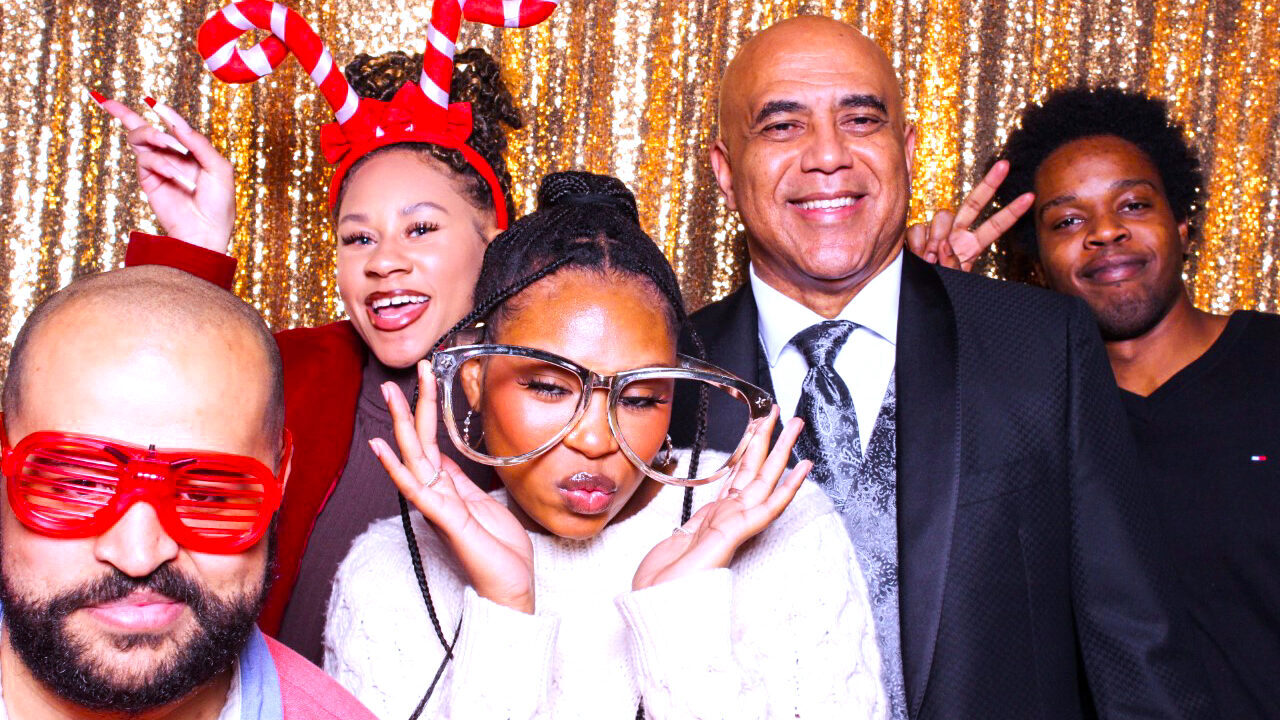 Pariveda employees smile with photo booth props