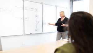 Pariveda leader presenting at a whiteboard in a conference room in the Chicago office