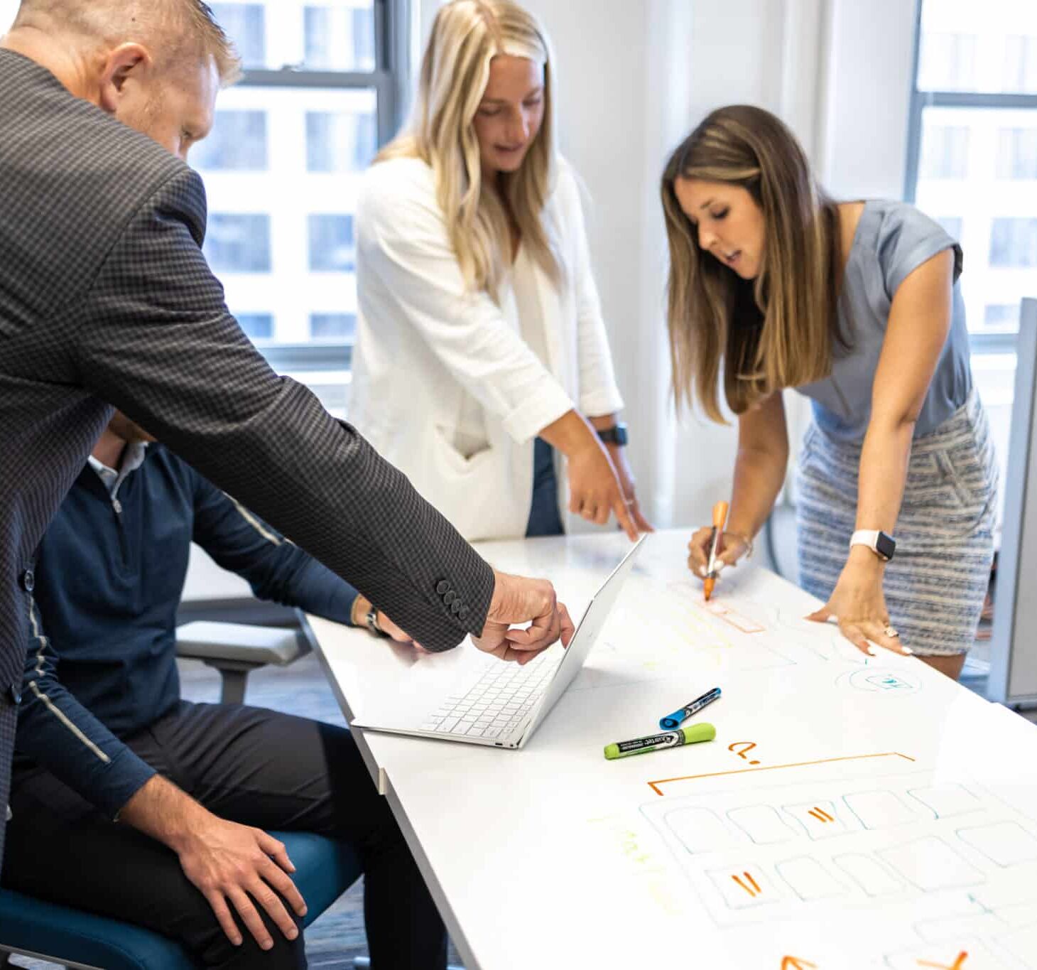 Pariveda employees working around a table together