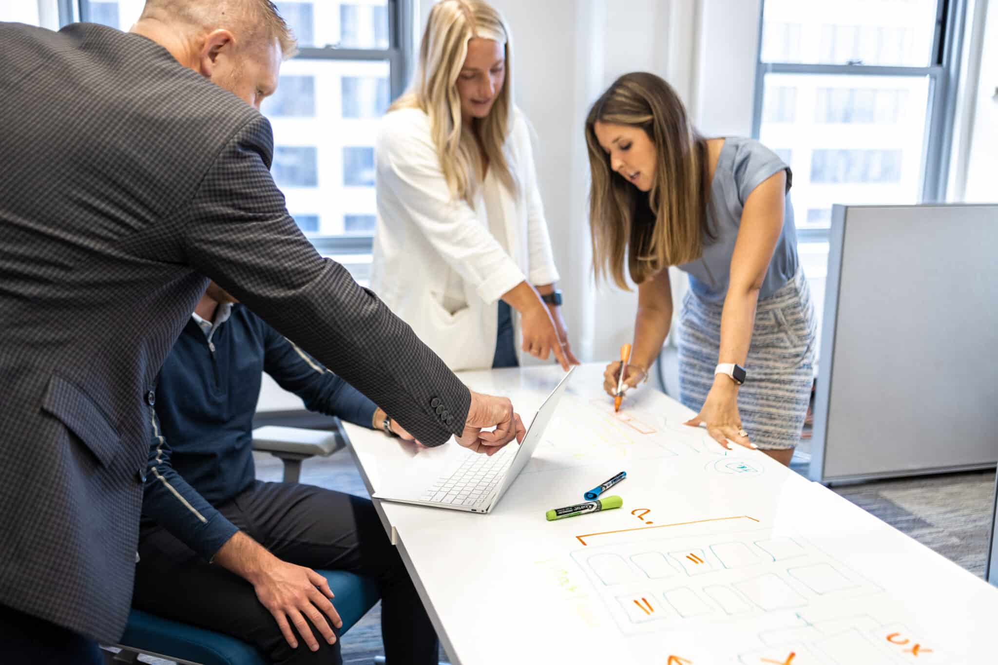 Pariveda employees working around a table together