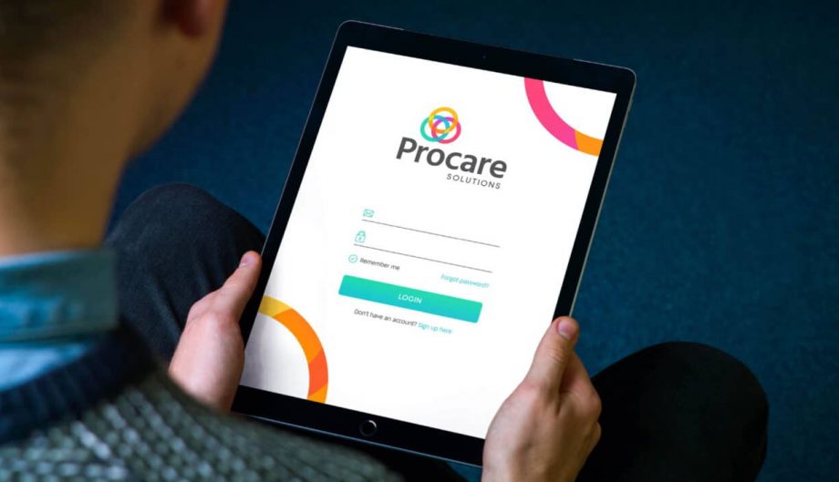 anonymous person holding an ipad with Procare Solutions login screen with new branding
